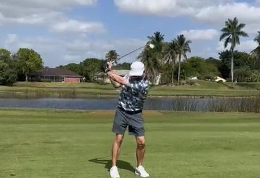 The founder mid-swing on a Florida course