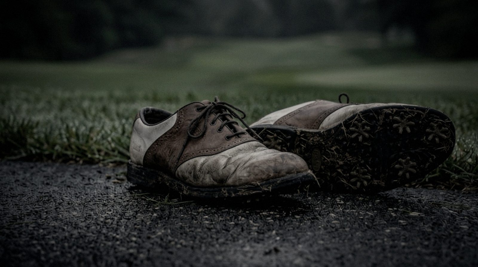 Worn golf shoes on a path