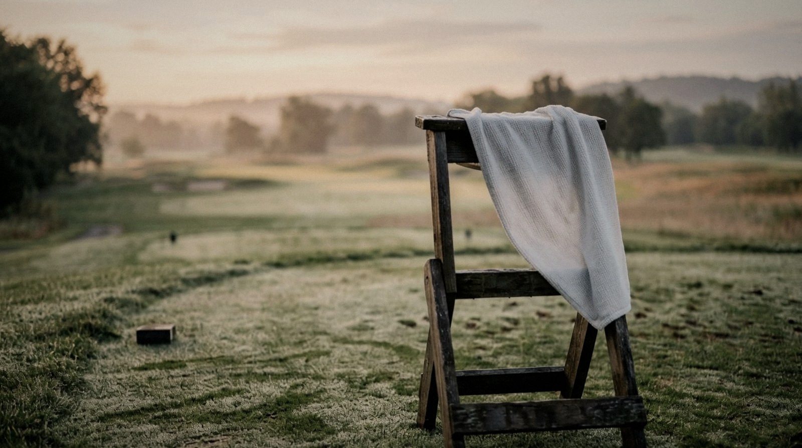 A towel over a tee marker at sunrise